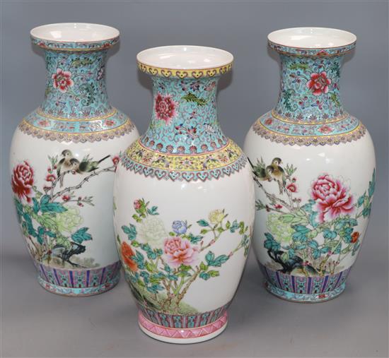 A pair of Chinese famille rose vases and another similar (3) Height 36cm